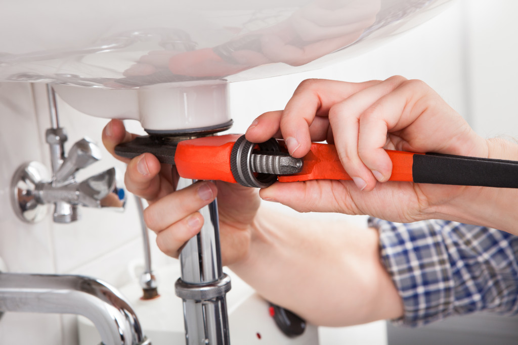 male plumber fixing a sink