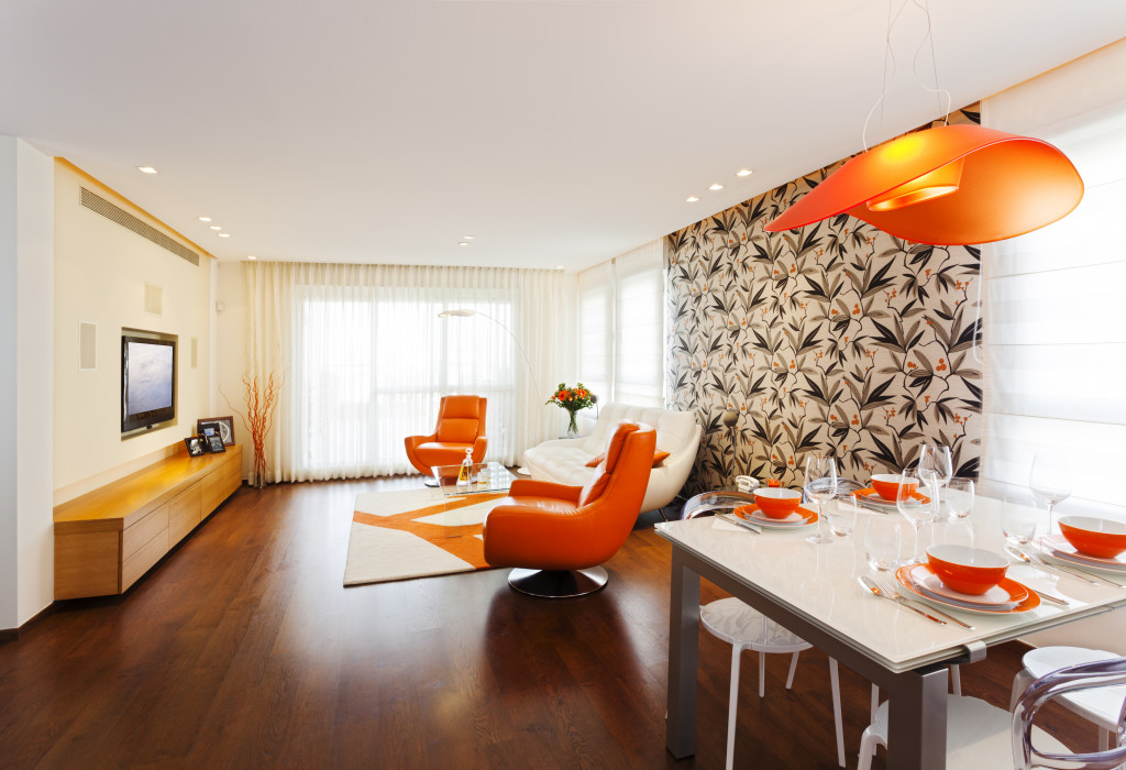 a beautifully-designed lviing room with orange utensils and chairs
